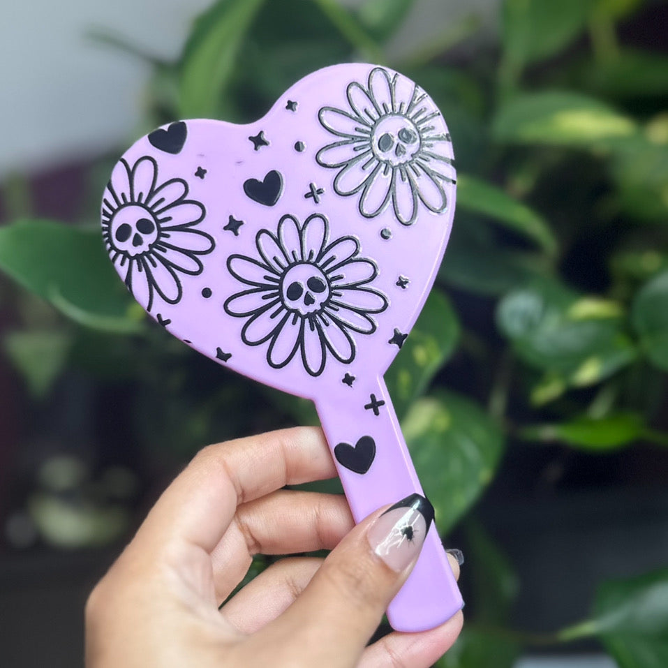 Deadly daisies handheld mirror